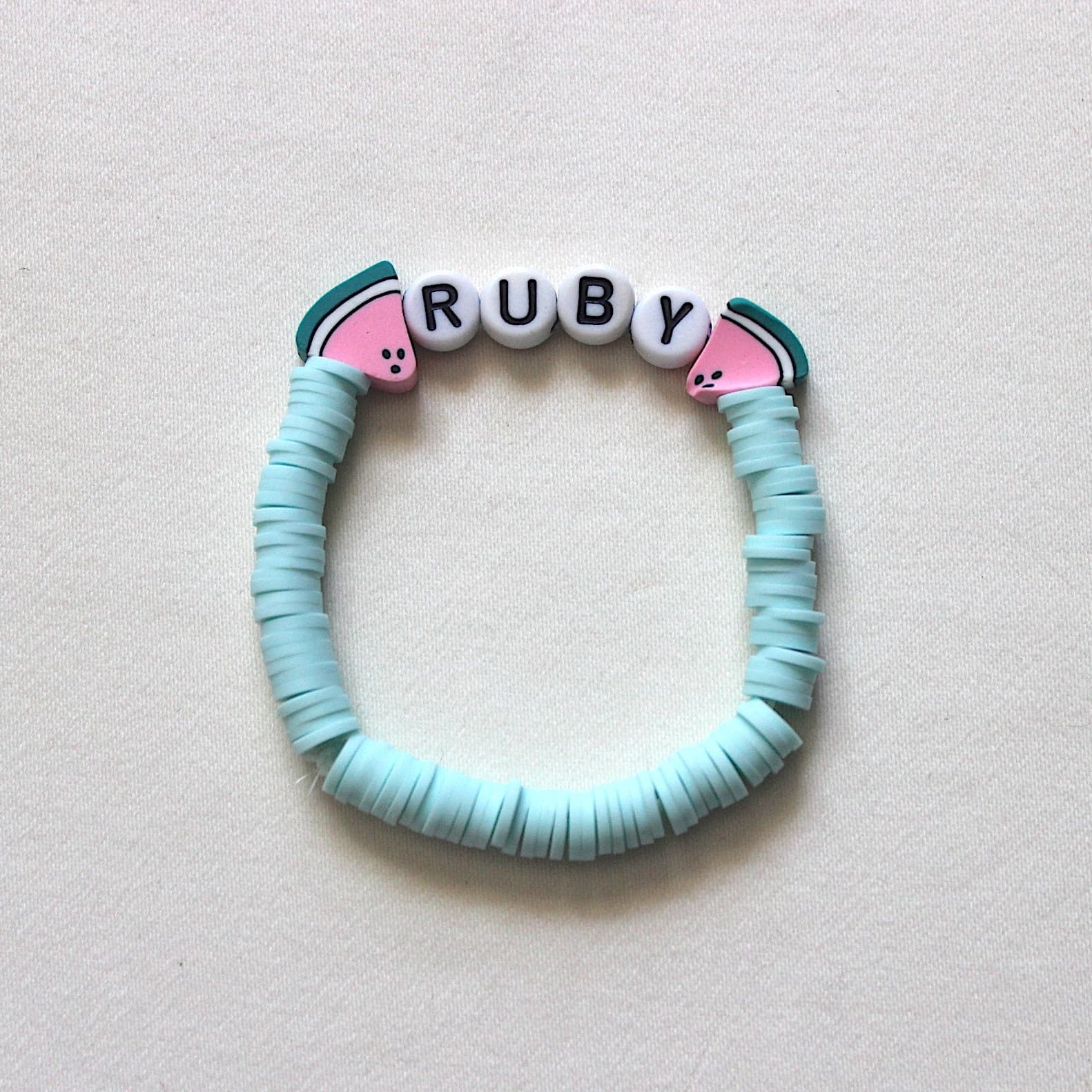 A handmade friendship bracelet spelling RUBY